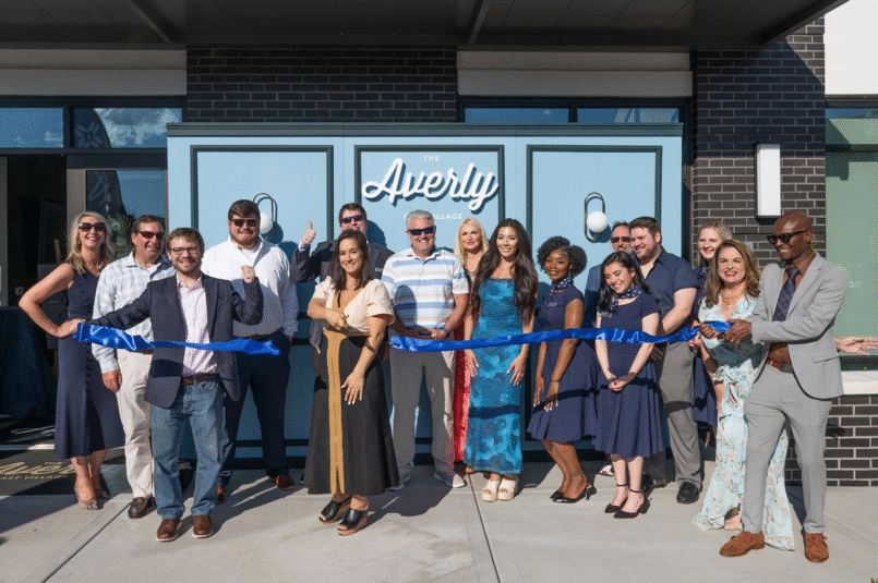 A group of ECI employees cutting the ribbon at The Averly East Village Grand Opening